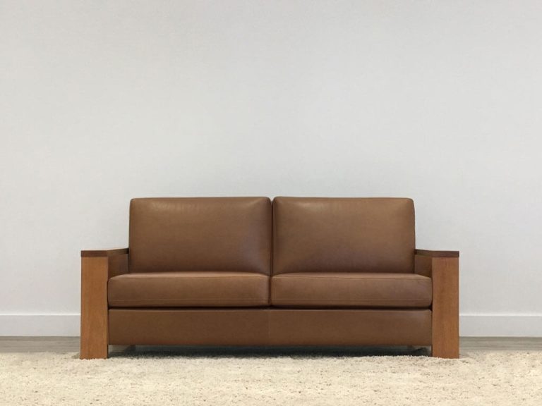 brown leather 2 seater lounge with timber arms and square cushions made in adelaide