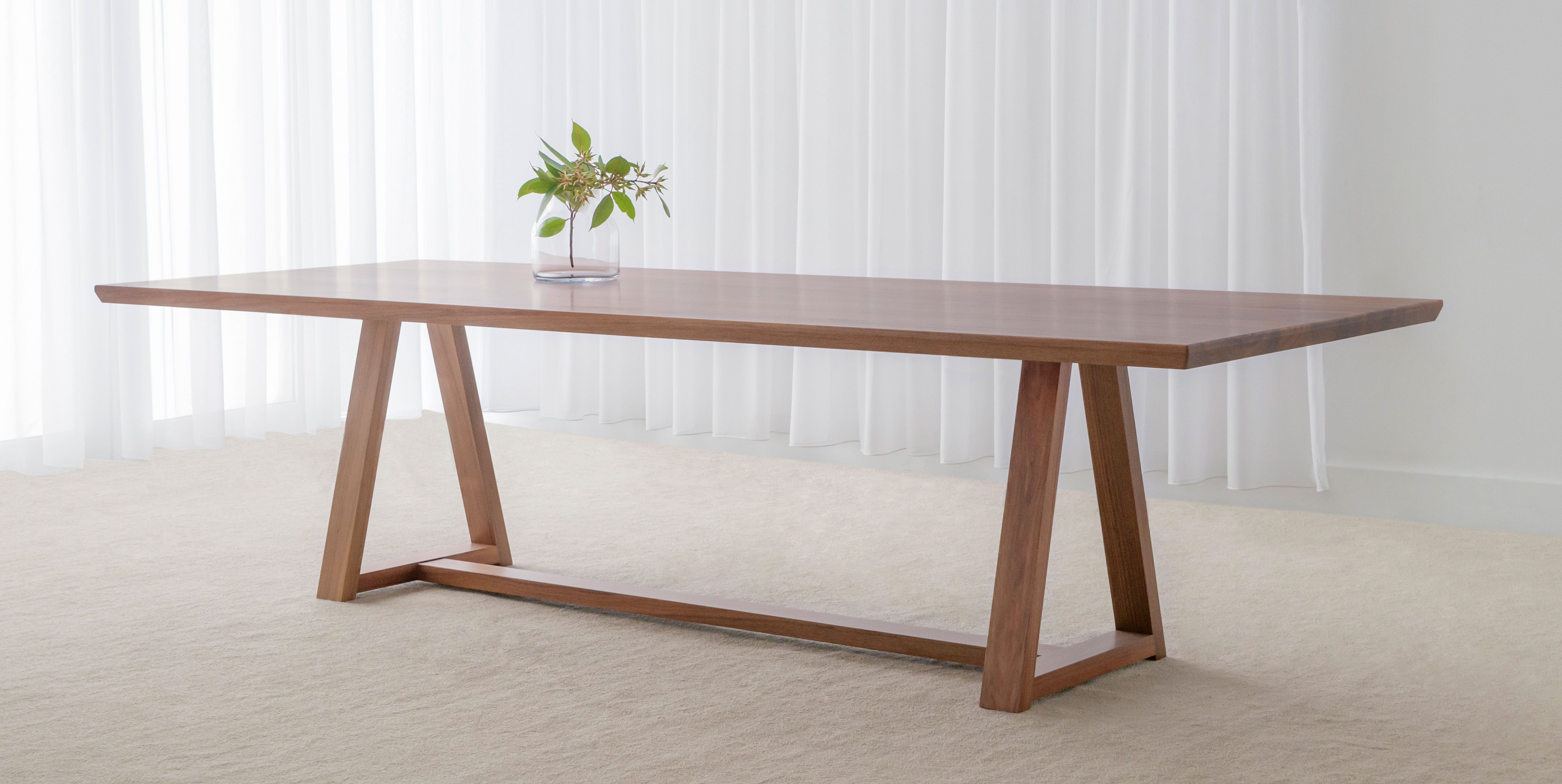 Trestle Dining Table made from blackwood timber with slim top and open base