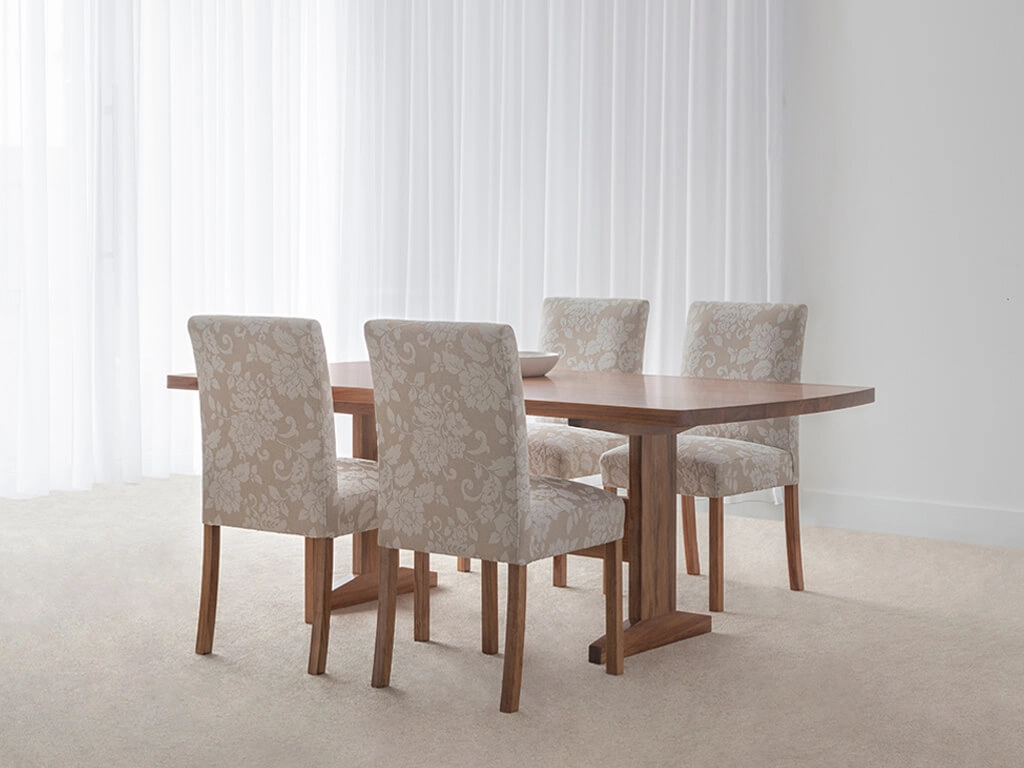 spacious dining table with modern pedestal base and curved corners made in custom tone hardwood timber