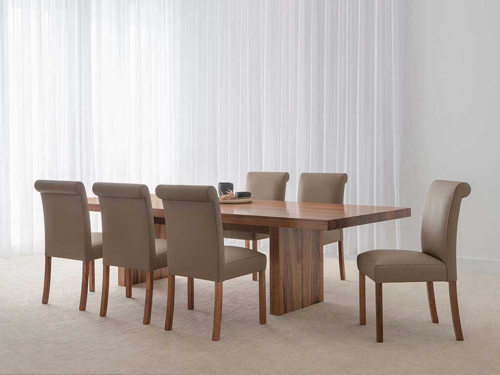 spacious dining table with modern pedestal base and curved corners made in custom tone hardwood timber