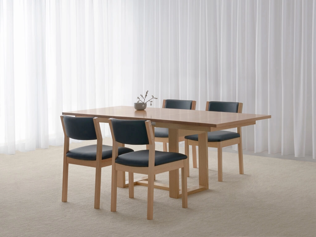 testle base dining table with tapered table top and slim features crafted in blackwood timber