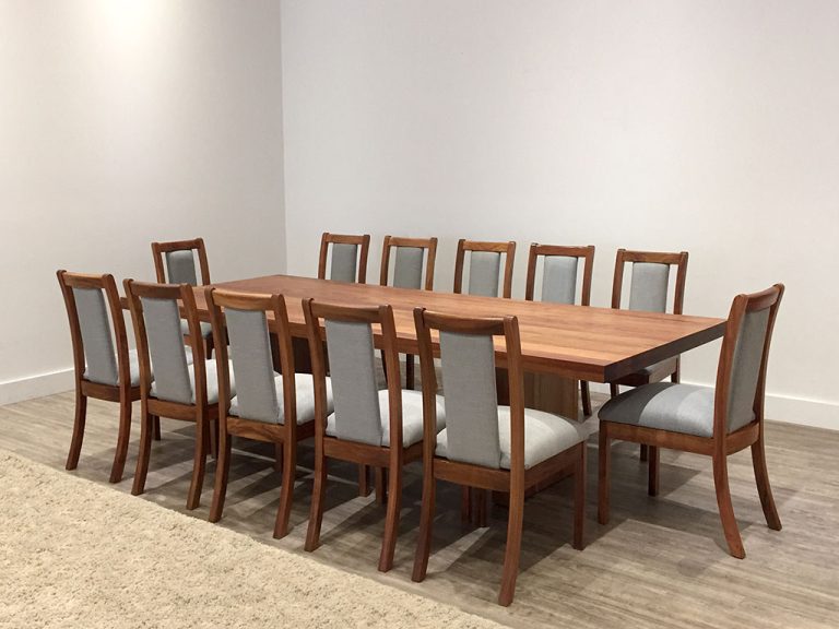 custom timber dining table with ornate table edge and traditional base