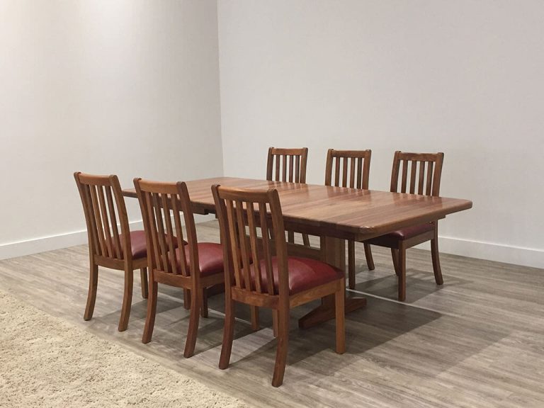 round timber dining table toned with pedestal base and tapered circular top