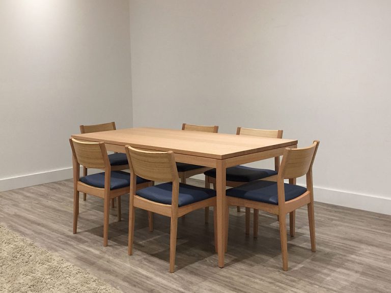 6 seater to 8 seater oak dining table with slim legs and modern timber back chairs