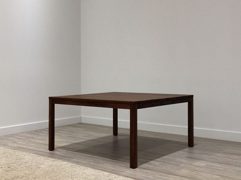 chocolate toned timber square dining table with four legs and tapered corners