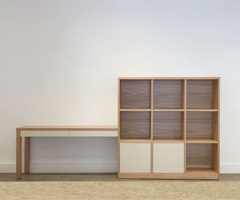 australian tasmanian oak timber made work station with elongated 2 drawer desk with white fronts, attached shelving unit with 7 shelves and 2 door cupboard below with white fronts