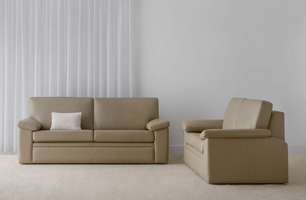 comfortable leather lounge suite made in adelaide with deep cushions and padded arm rests on full base