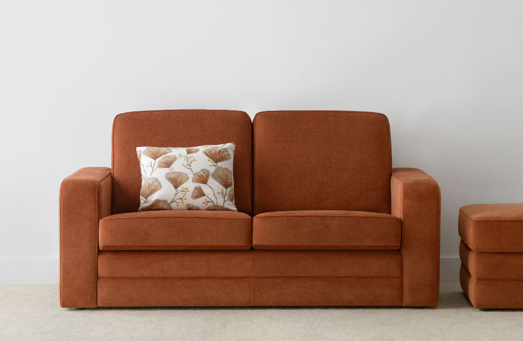 2.5 seater fabric sofa in burnt orange colour with high back and full base with matching ottman