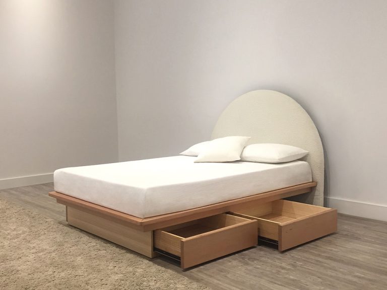 australian timber made bed with arched fabric headboard and storage space