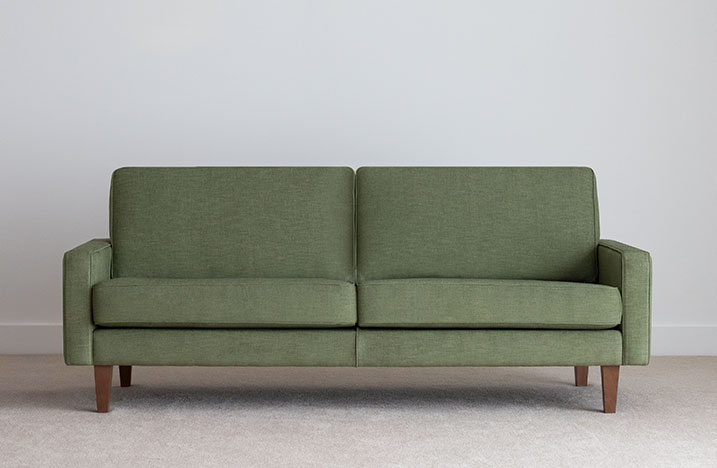 3 seater green fabric sofa on leg with thin arm