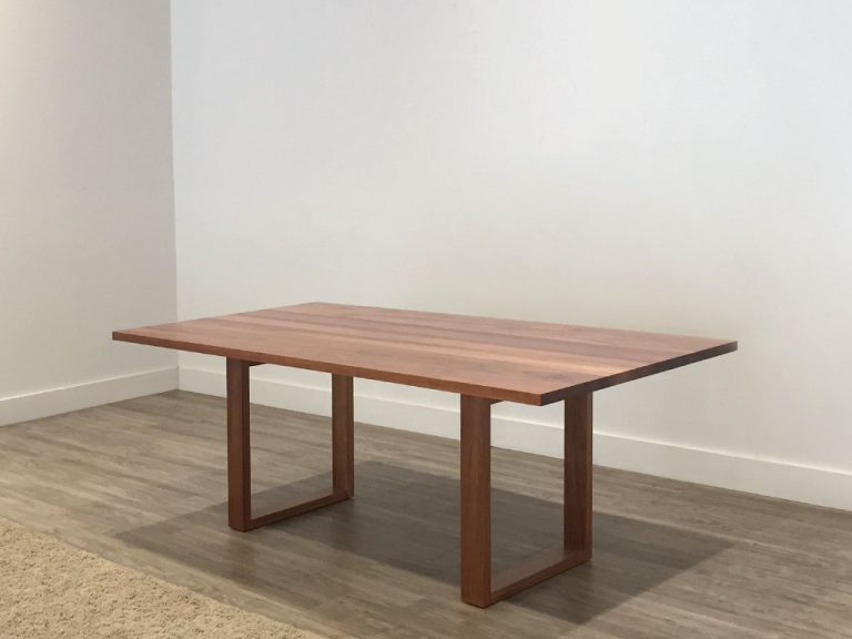 small timber dining table with sleek open base in tasmanian blackwood timber